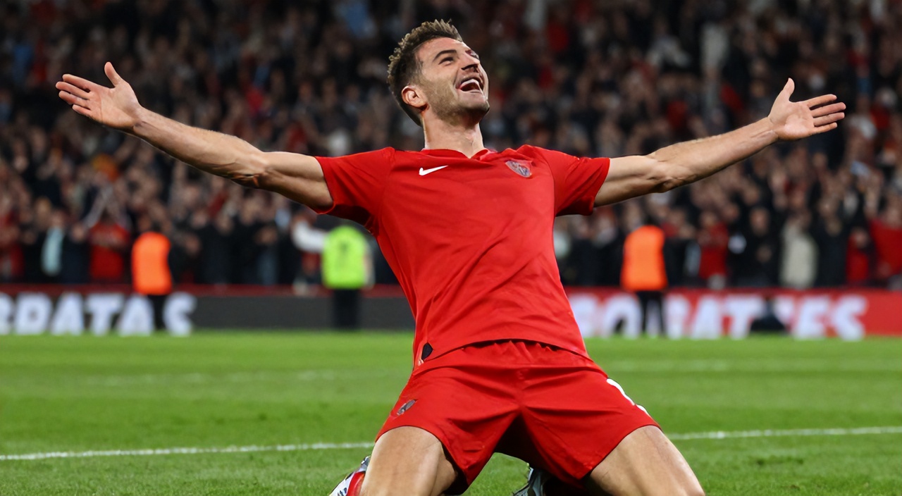 Gol sonrası kollarını açıp diz üstü kayan kırmızı formalı futbolcu